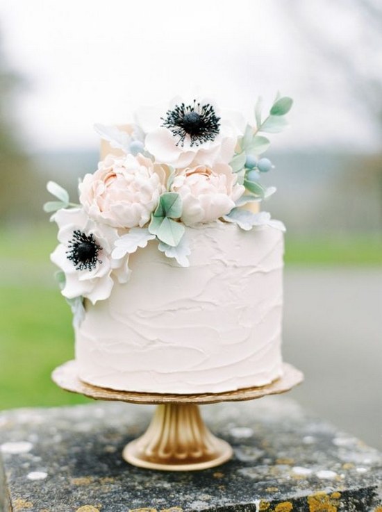 Anemone-adorned cake for a crisp white wedding