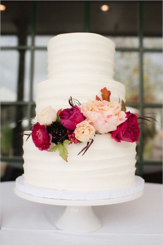 white wedding cake with red flowers