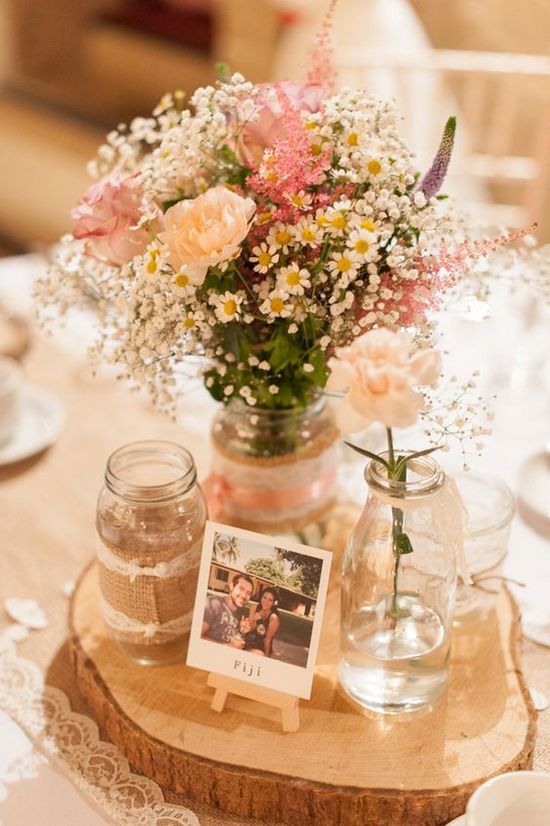 Pastel rustic table centrepieces with polaroid photos as table names