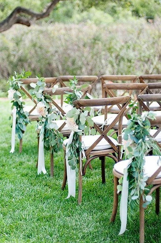 Greenery with cream ribbons is simple, lovely aisle decor