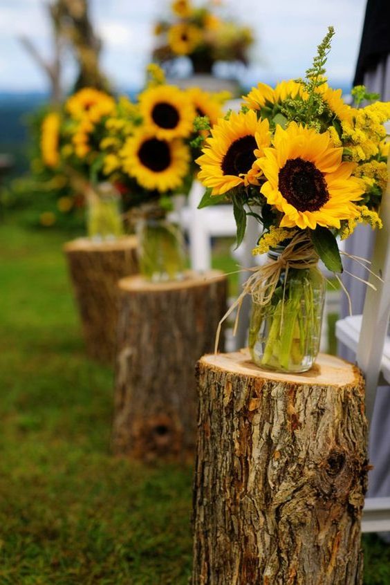 fall wedding aisle decorated by mason jars and sunflowers