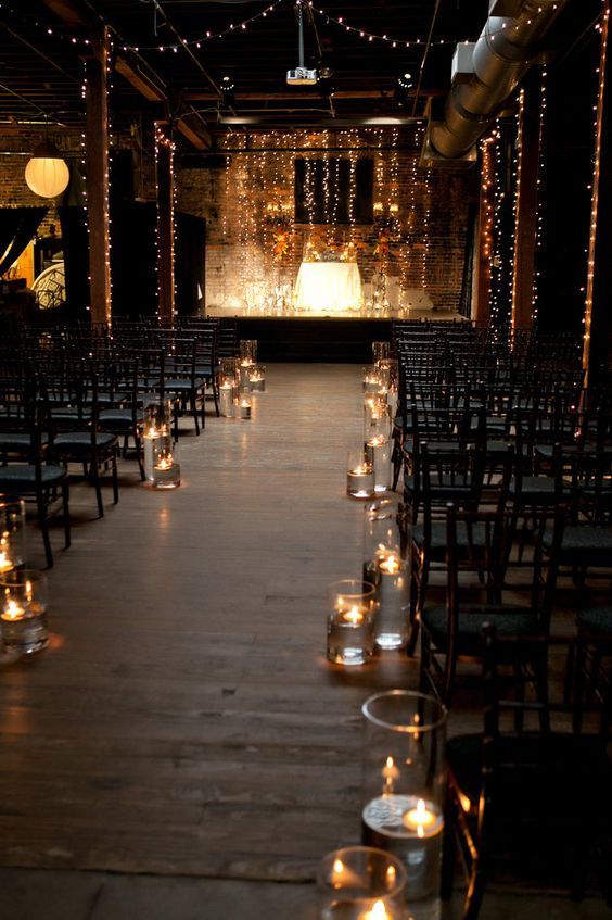 mpossibly romantic wedding ceremony set-up with twinkle lights and floating candles