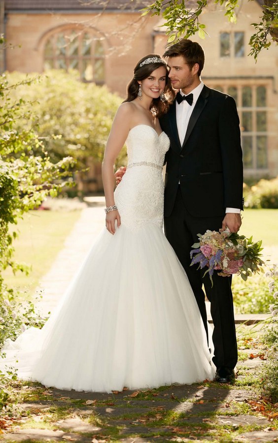 Curve-hugging linear lace on a plunging bodice make this stunning fit-and-flare wedding dress from Essense of Australia