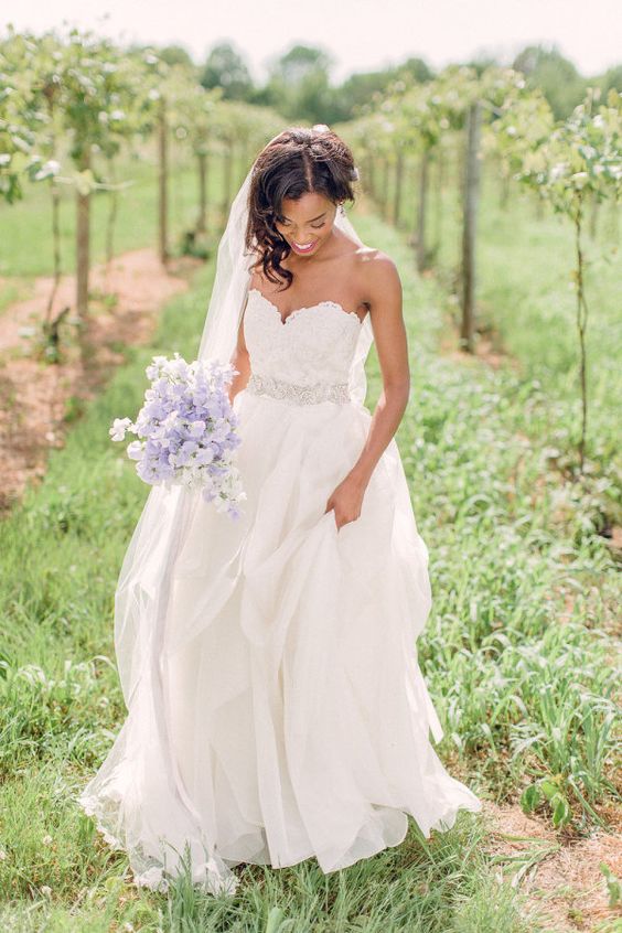 Soft lilac bouquet and a sweetheart neckline wedding dress