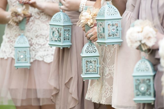 Rustic lanterns resting in lush floral wreaths make for lovely centerpieces
