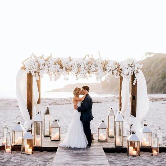 flowers and lanterns and the finished look with the risers in the sand