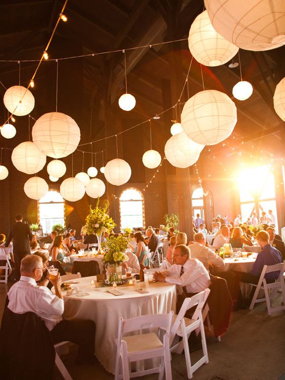 hanging paper lanterns and strands of cafe lights create a warm glow