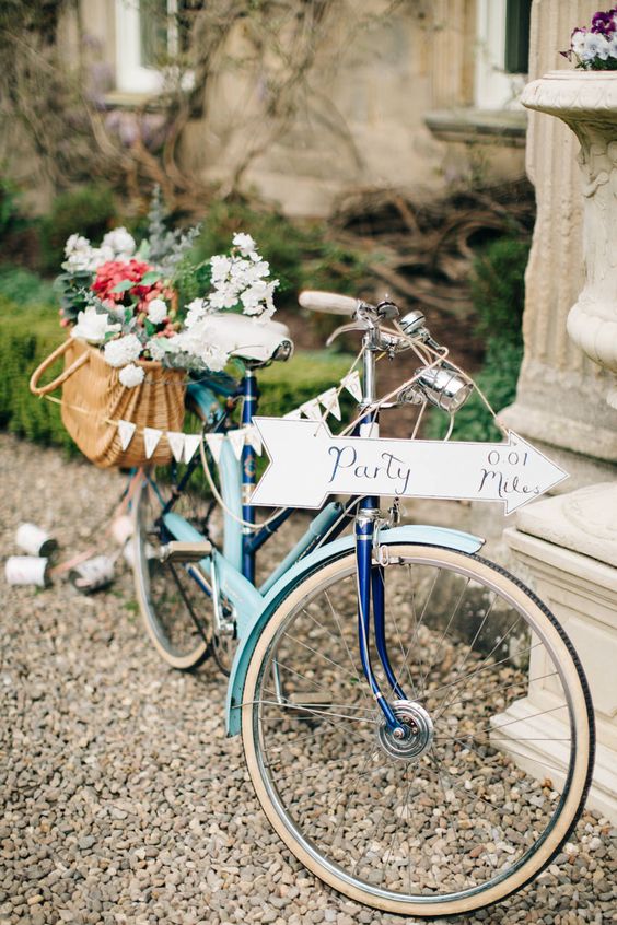 Vintage bicycle with basket full of flowers, Bunting & Direction Sign
