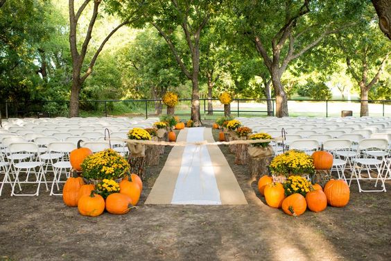 country wedding ceremony decor with large pumpkins