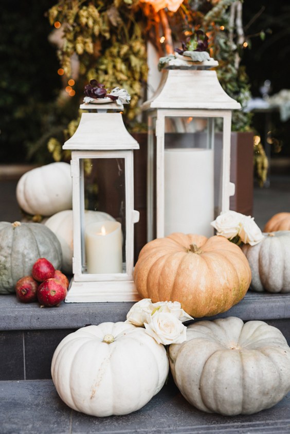 white lantern and pumpkins wedding decor