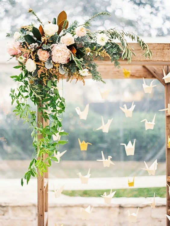 Wine barrels, Queen Anne’s lace flower arrangements, draped linens and an origami bird curtain