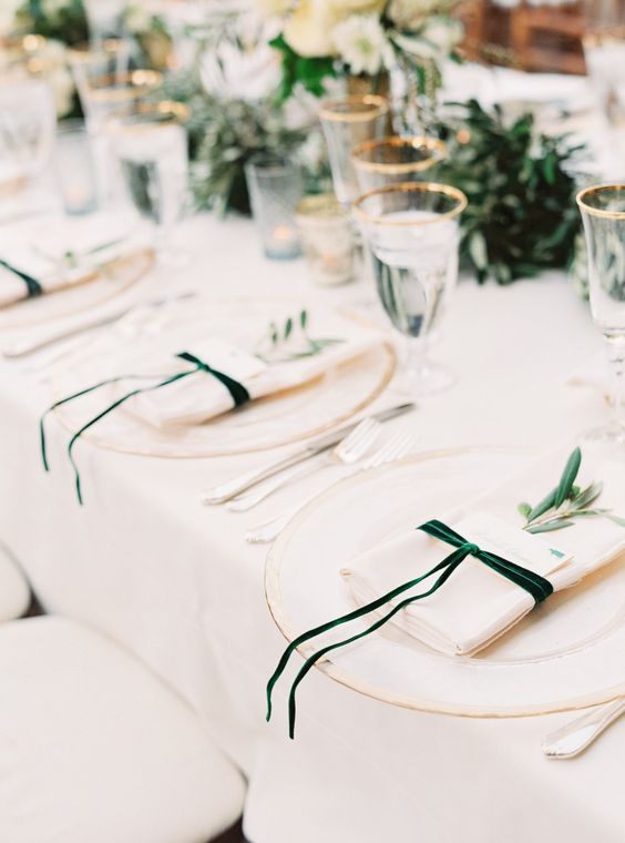 velvety green ribbons around the napkins at this wedding table place setting