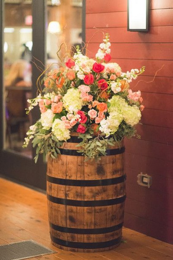 rustic chic wedding decor lush and colorful flower arrangements antique wine barrels