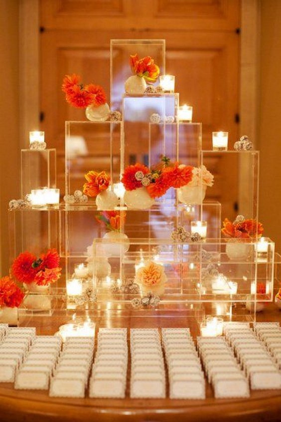 clear boxes with candles and flowers