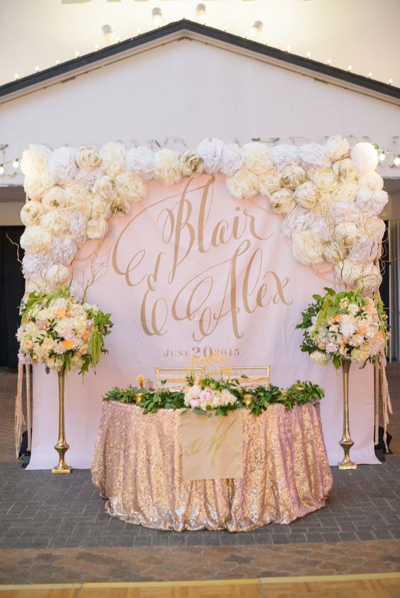 sweetheart table backdrop with large gold calligraphy monogram