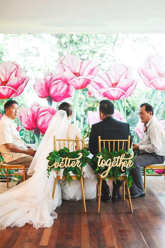 better together sweetheart chair signs and giant pink flower garden backdrop