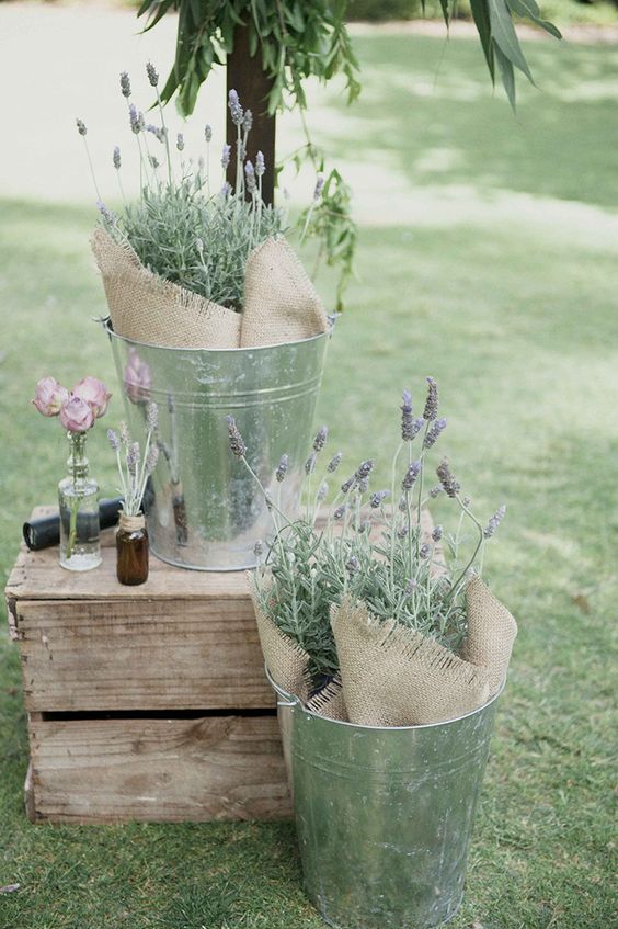 Silver buckets of lavender and burlap for rustic wedding ceremony via LoveHer Photography