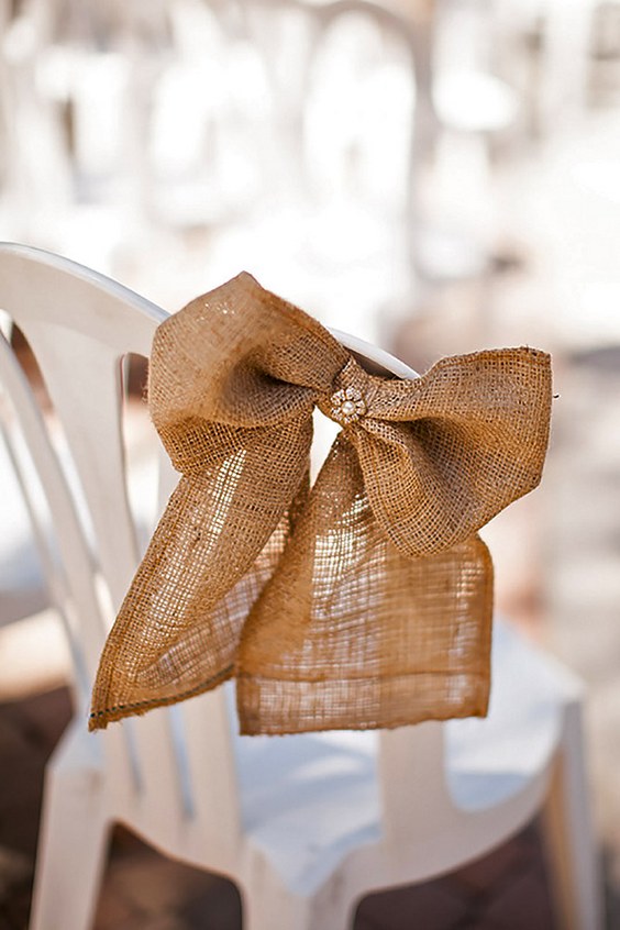 burlap bow wedding chair decor via kevin le vu photography