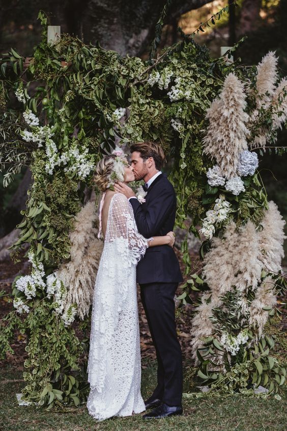 greenery flowers and pampas grass wedding alter