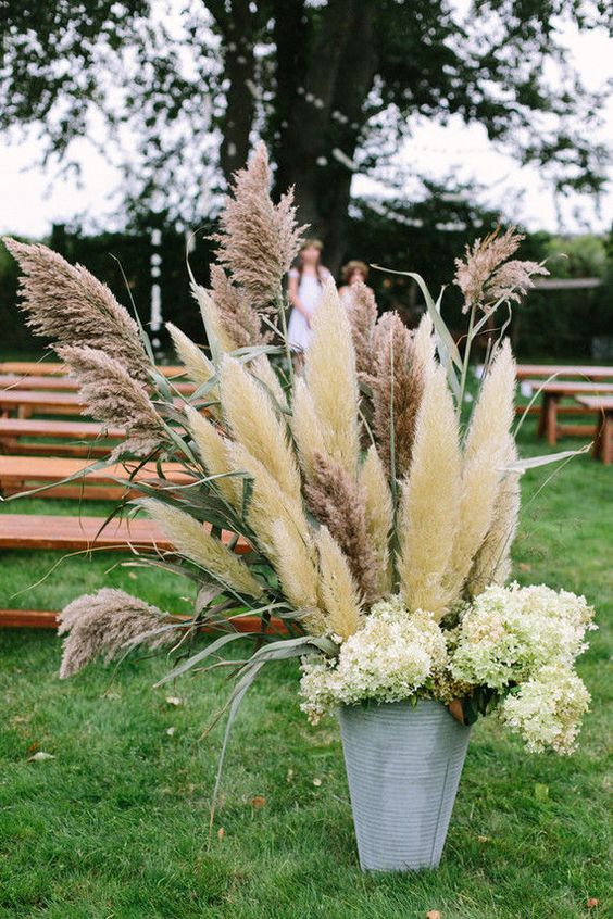 rustic wedding ideas – overflowing bucket filled with an eclectic mix of bucolic greens