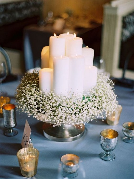 Long baby’s breath table runner draped across long wooden table and onto floor
