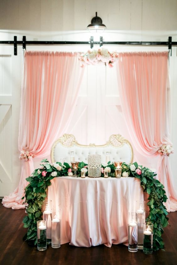 Blush and gold sweetheart table with garland