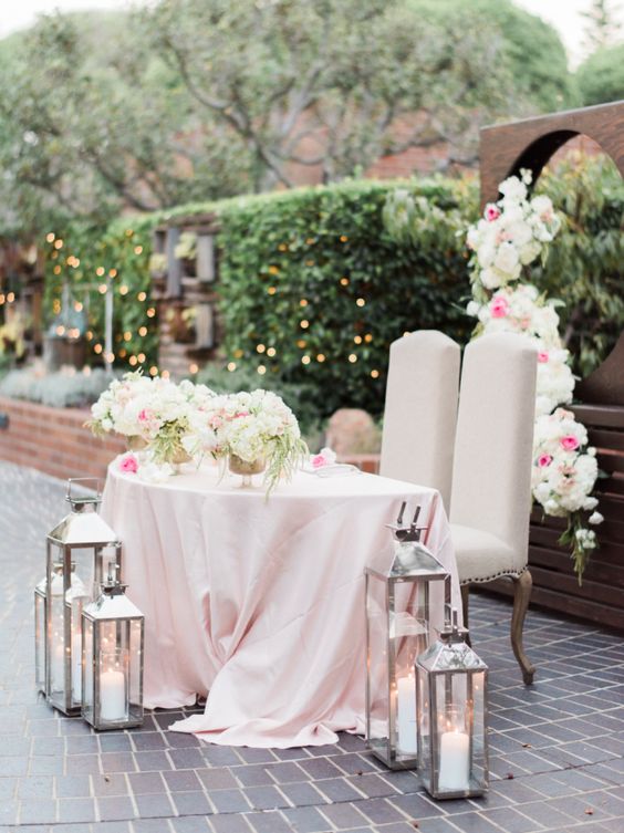 Blush pink floral accented bride and groom table via Honey Honey