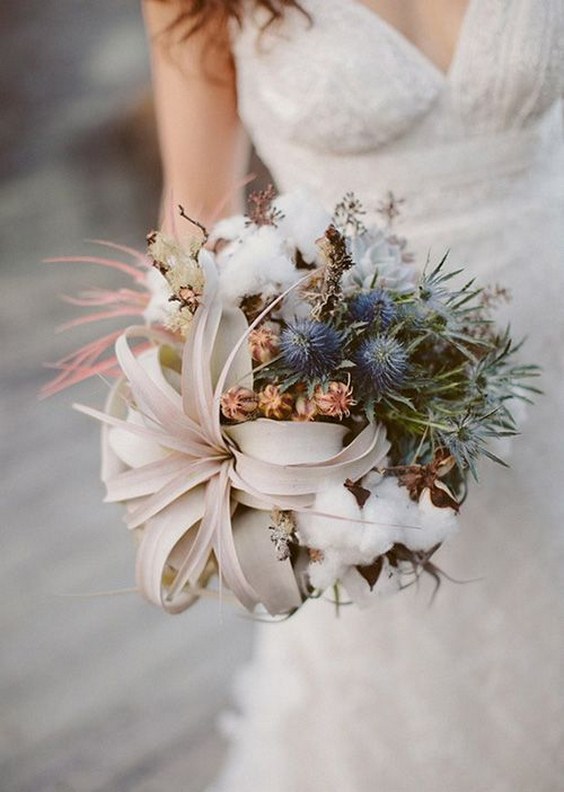 Organic wedding bouquet with air plants, blue thistles, and cotton