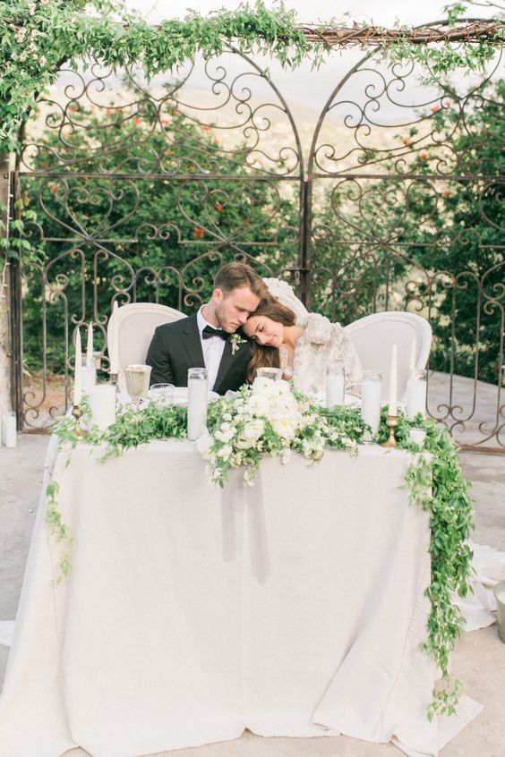 sweetheart table with candlescape and greenery garland