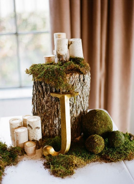 wood stump, monogrammed lettering and candles wedding centerpiece