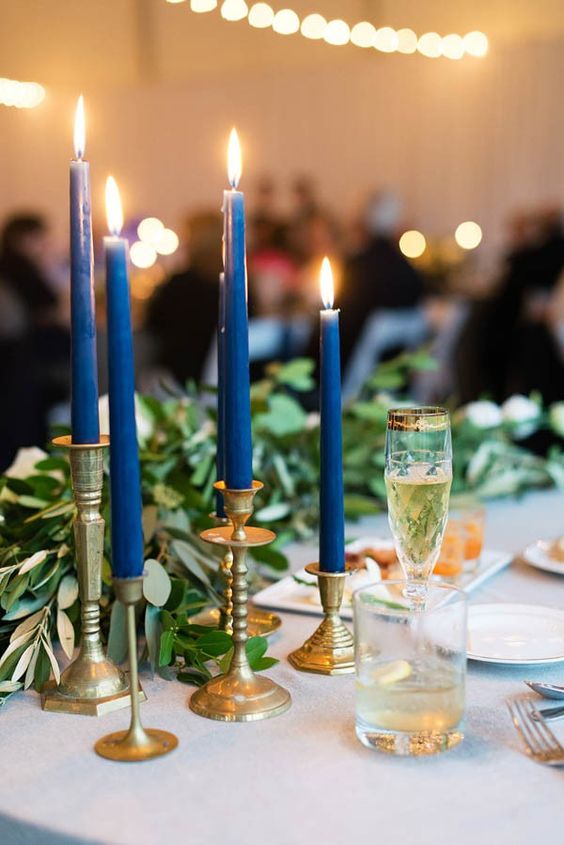 Vintage gold candlesticks with navy candles
