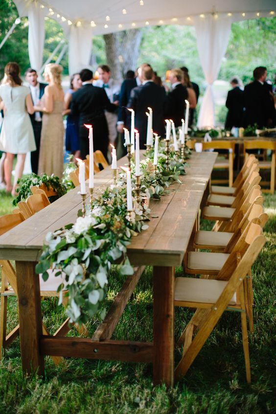 greenery and white candle wedding centerpiece