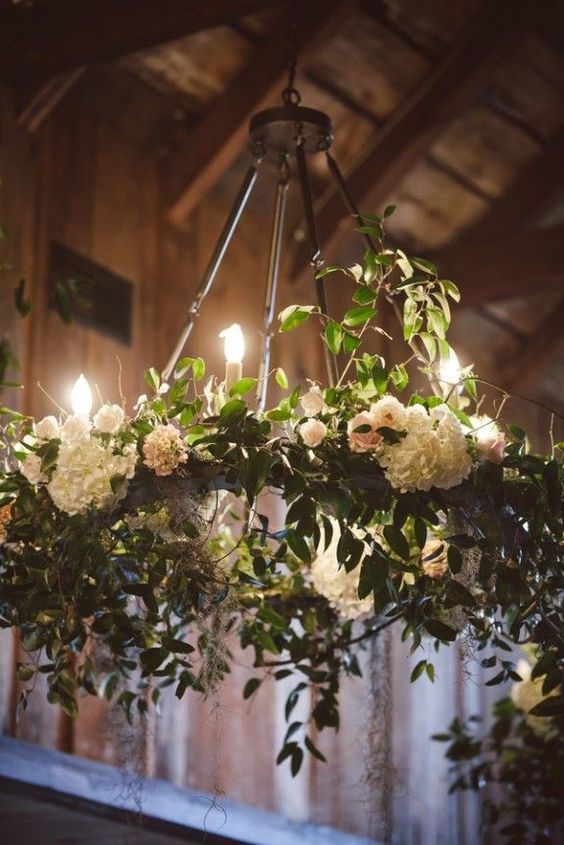 white flowers and greenery wedding chandelier via via amelia + dan photography