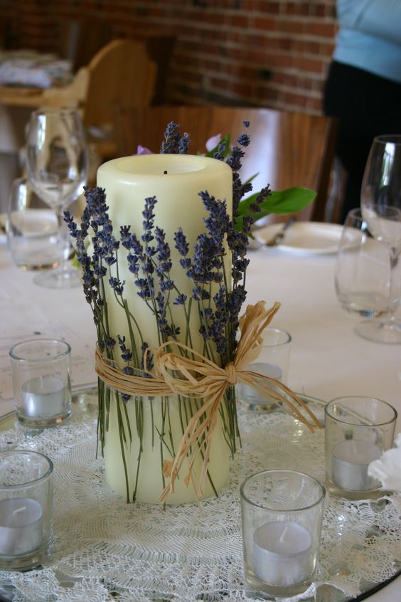 simple table centre idea wrapping dried lavender around a large church candle