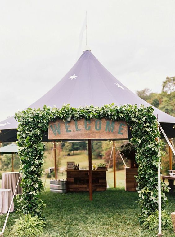 minimalist tent wedding with wooden accents and floral