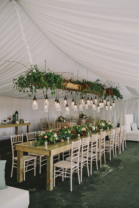 rustic tent wedding decor with hanging greenery centerpiece