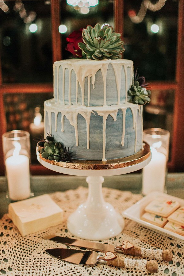 modern light watercolor blue wedding cake with drips and succulents