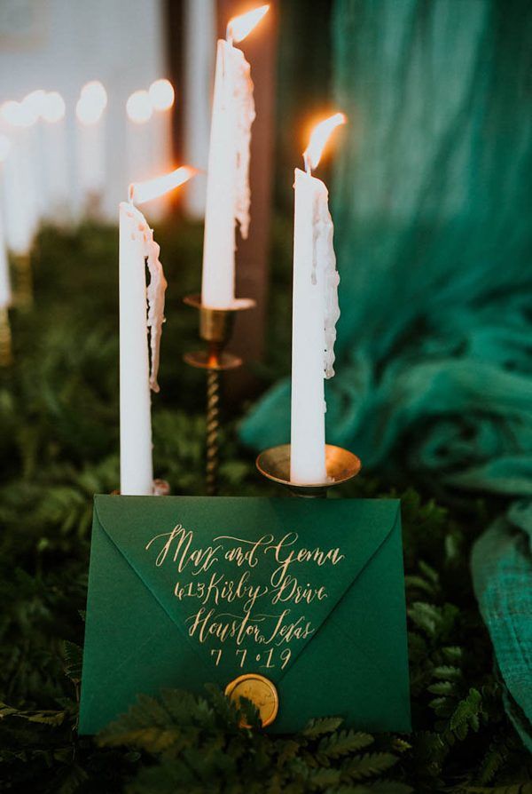 Emerald invitation before enchanting candles