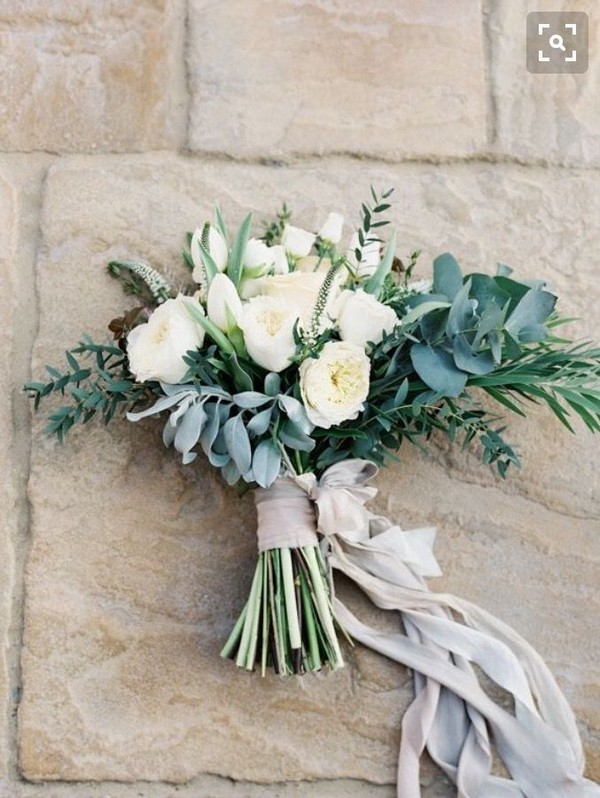 Lots of greenery, messy and pretty trailing ribbons wedding bouquet