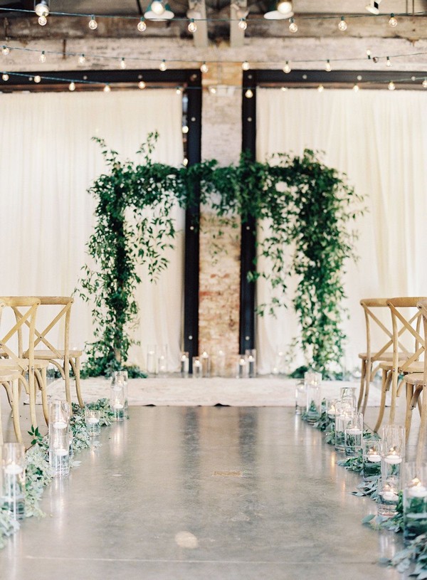 industrial wedding ceremony decoration ideas with greenery garlands aisle and arches