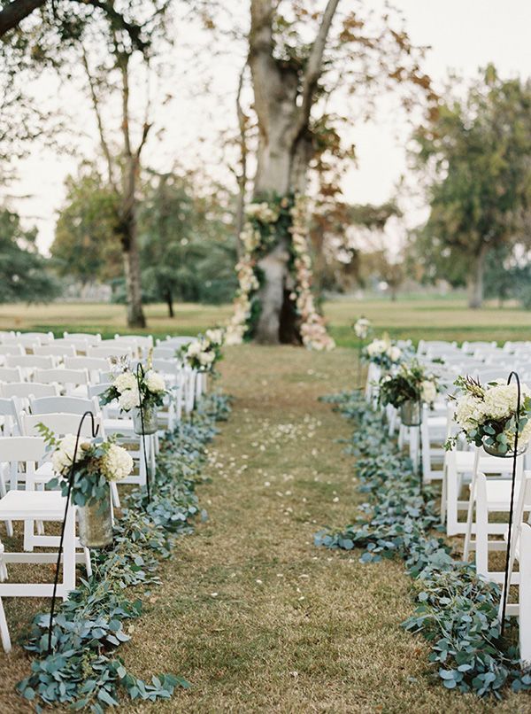 outdoor wedding ceremony decor consisted of greenery garlands of eucalytpus to line the aisle