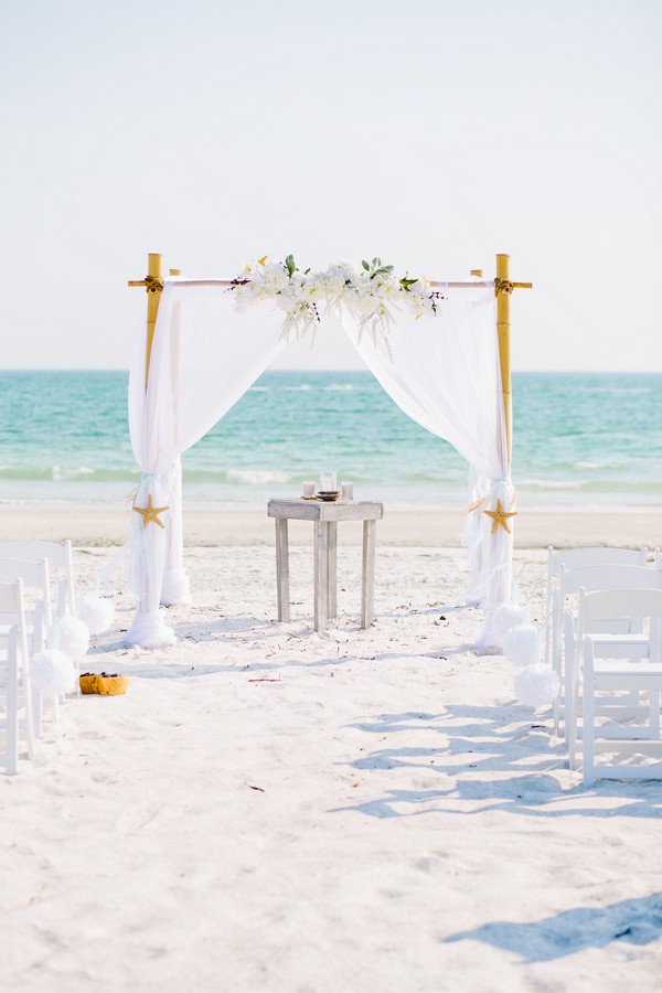 Elegant white beach wedding arbor