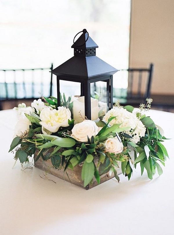 black lantern and white flowers wedding centerpiece