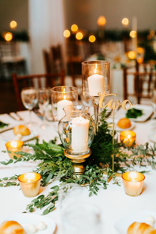 vintage candles and greenery wedding centerpiece