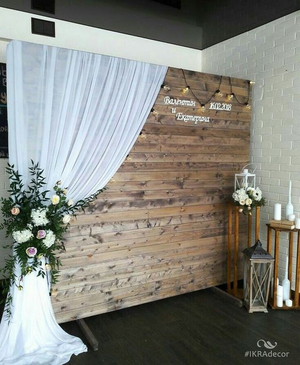creative wooden wedding photo booth with white drapery