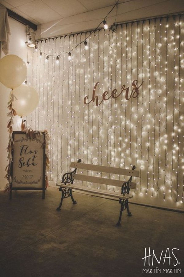 homemade photo booth with twinkle lights and signs