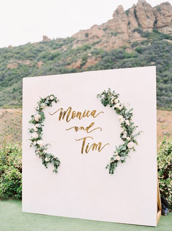 white and greenery chic outdoor wedding photo booth