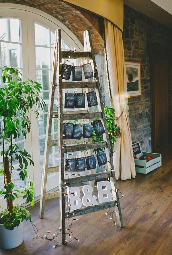 a seating plan with a ladder and chalkboard seating chart plus monograms and LEDs