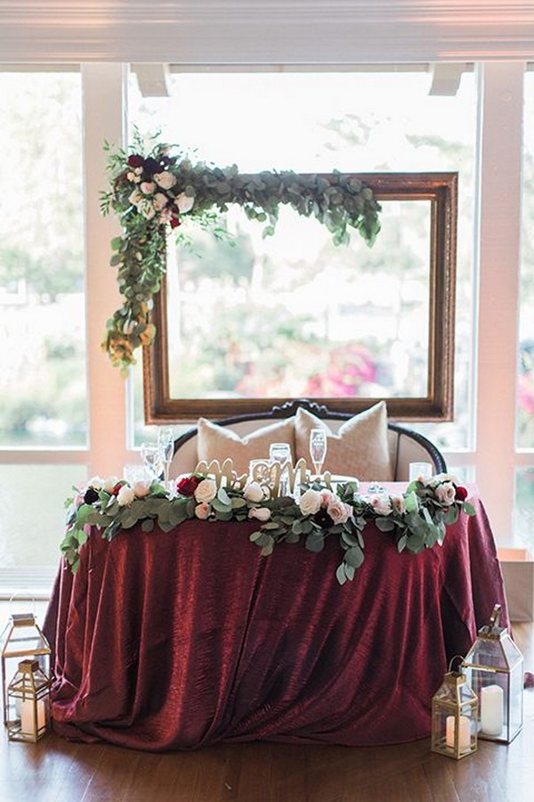 greenery and burgundy sweetheart table decor