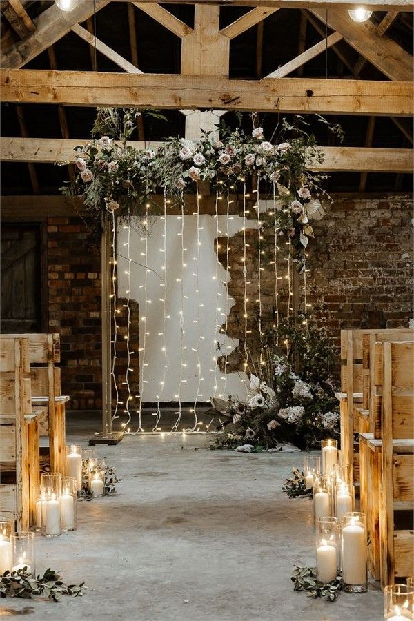 rustic wooden benches and floral fairy light backdrop, candle aisle decorations